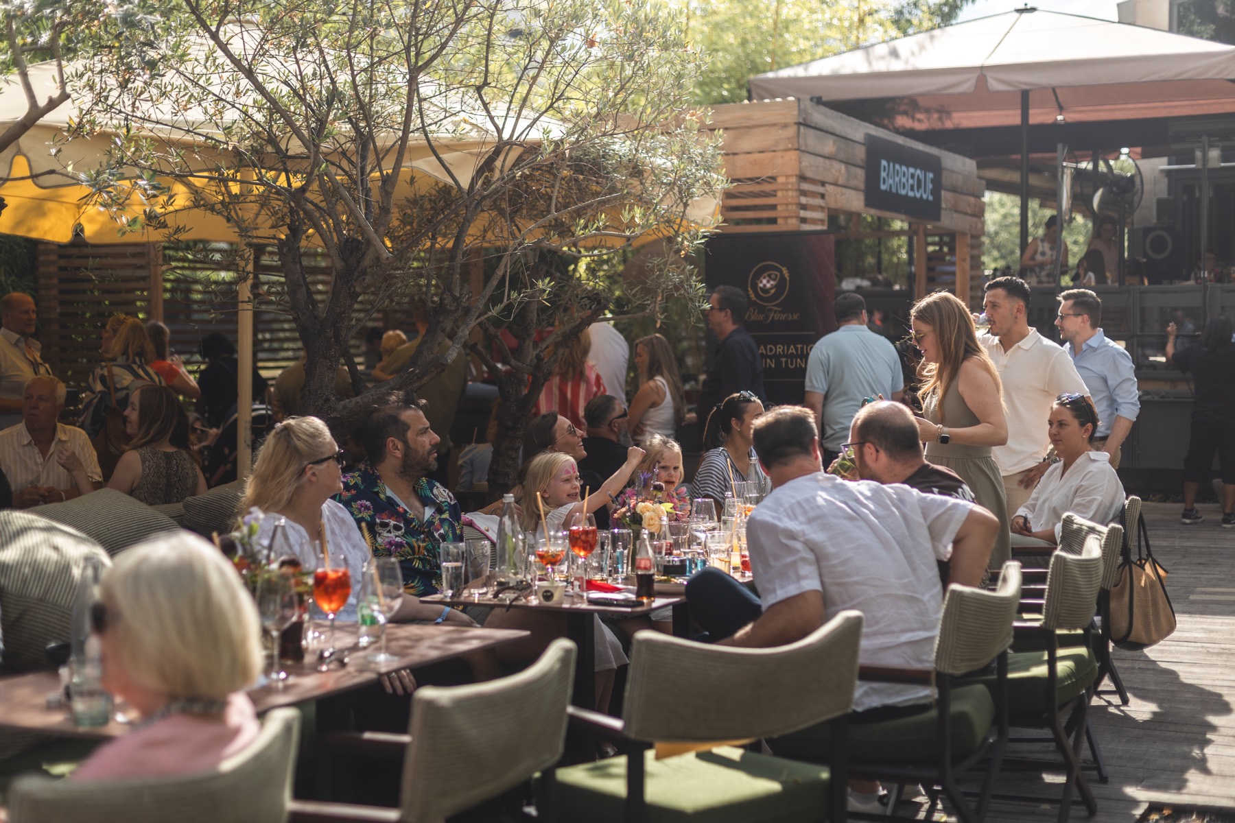 Guests at long tables at the summer party
