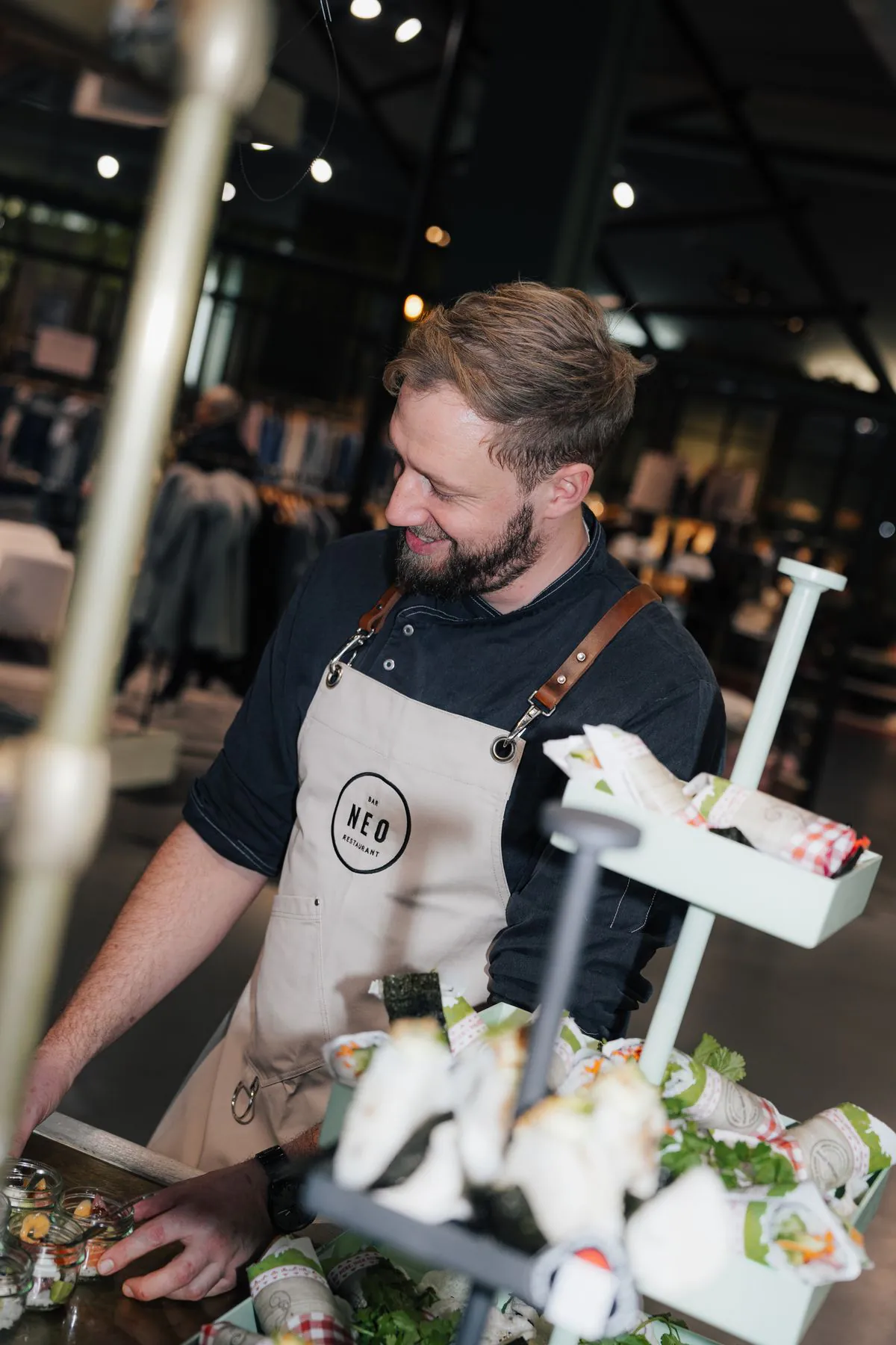 Chef in a NEO apron at the live catering station